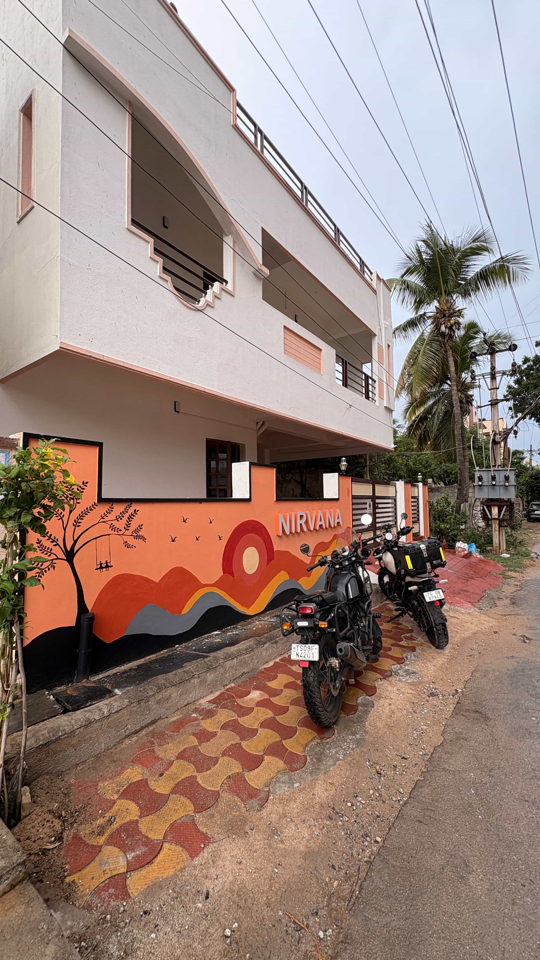 Painted front wall and entrance of Nirvana Backpackers hostel, Tirupati